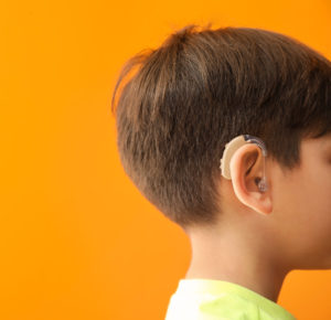 Boy with hearing aid